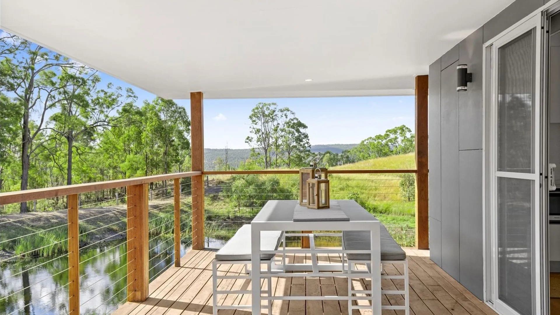 A completed 6Homes modular home installed in bushland beside a dam